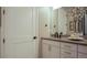 Modern bathroom with white cabinets, dark countertops, and mosaic tile at 6922 Copper Sky Cir, Castle Pines, CO 80108