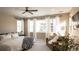 Bright bedroom with large windows, comfy seating, and a ceiling fan at 6922 Copper Sky Cir, Castle Pines, CO 80108