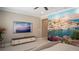 Unique bedroom featuring a scenic mural wall, a comfortable bed, and a modern entertainment center at 6922 Copper Sky Cir, Castle Pines, CO 80108