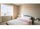 Bedroom with double bed, window, and light pink bedding at 6922 Copper Sky Cir, Castle Pines, CO 80108