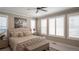 Elegant bedroom with a tufted headboard bed, shuttered windows, decorative pillows, and a cozy bench at 6922 Copper Sky Cir, Castle Pines, CO 80108