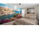 Beautifully decorated bedroom featuring a unique mural, comfortable bed, and stylish accents at 6922 Copper Sky Cir, Castle Pines, CO 80108