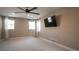 Bright bedroom with ceiling fan and wall-mounted TV at 6922 Copper Sky Cir, Castle Pines, CO 80108