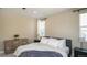 Cozy bedroom featuring a comfortable bed, neutral tones, wood dresser, and ample natural light from the window at 6922 Copper Sky Cir, Castle Pines, CO 80108