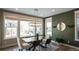 Bright dining room with glass table and green accent wall at 6922 Copper Sky Cir, Castle Pines, CO 80108
