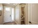 Bright entryway with powder room, wood floors, and a white door at 6922 Copper Sky Cir, Castle Pines, CO 80108