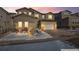 Two-story home with stone and siding accents, attached garage, and landscaping at 6922 Copper Sky Cir, Castle Pines, CO 80108