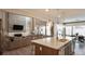 Modern kitchen with large island, white cabinets, and stainless steel appliances at 6922 Copper Sky Cir, Castle Pines, CO 80108
