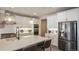 Modern kitchen featuring stainless steel appliances, white cabinetry, a spacious island with bar seating, and pendant lighting at 6922 Copper Sky Cir, Castle Pines, CO 80108