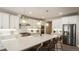 Modern kitchen with large island, white cabinets, and stainless steel appliances at 6922 Copper Sky Cir, Castle Pines, CO 80108