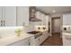 Modern kitchen with white cabinets, gas cooktop and stainless steel appliances at 6922 Copper Sky Cir, Castle Pines, CO 80108