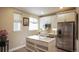 Basement kitchen with white cabinets, stainless steel appliances, and an island at 6922 Copper Sky Cir, Castle Pines, CO 80108