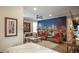 Stylish living room with comfortable seating, a city skyline mural, and modern decor at 6922 Copper Sky Cir, Castle Pines, CO 80108