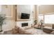 Living room with sectional sofa, fireplace, and large windows at 6922 Copper Sky Cir, Castle Pines, CO 80108