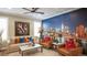 This welcoming living room boasts a unique city skyline wall mural and stylish decor at 6922 Copper Sky Cir, Castle Pines, CO 80108