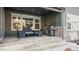 Covered patio with stone flooring, seating and grill at 6922 Copper Sky Cir, Castle Pines, CO 80108