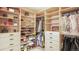 Custom-built walk-in closet with shelves and hanging rods at 6922 Copper Sky Cir, Castle Pines, CO 80108