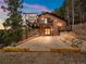 Back of house with a nice stone patio and elevated deck perfect for outdoor entertaining at 11093 Milliken Ave, Conifer, CO 80433