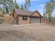 Attached two-car garage offers convenient parking and storage space at 11093 Milliken Ave, Conifer, CO 80433