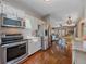 Kitchen view that flows into the living room and dining area with stainless steel appliances at 11093 Milliken Ave, Conifer, CO 80433