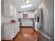 Well-lit kitchen featuring stainless steel appliances, skylight, and white cabinets at 11093 Milliken Ave, Conifer, CO 80433