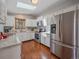 Bright, clean kitchen featuring stainless steel appliances, white cabinetry and granite countertops at 11093 Milliken Ave, Conifer, CO 80433