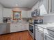 Bright kitchen showcasing stainless steel appliances, white cabinetry, and ample counter space at 11093 Milliken Ave, Conifer, CO 80433