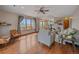 Sun-filled living room with wood floors and large windows offering scenic views at 11093 Milliken Ave, Conifer, CO 80433