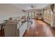 Open-concept living room with hardwood floors, neutral decor, and access to the outdoor deck at 11093 Milliken Ave, Conifer, CO 80433