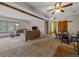 Spacious living room with ceiling fan, exposed beam, large windows, and seating at 11093 Milliken Ave, Conifer, CO 80433