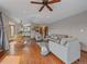 Bright and open living room featuring hardwood floors, neutral walls, and a ceiling fan at 11093 Milliken Ave, Conifer, CO 80433