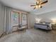 Spacious main bedroom with large windows, neutral tones, and a ceiling fan at 11093 Milliken Ave, Conifer, CO 80433