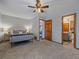 Cozy main bedroom featuring carpet flooring, neutral colors, and an ensuite bathroom at 11093 Milliken Ave, Conifer, CO 80433