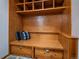 Mudroom featuring a built-in bench, drawers, coat hooks, and overhead shelving at 11093 Milliken Ave, Conifer, CO 80433