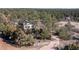Aerial view of a home nestled among trees, showcasing the spacious lot and wooded surroundings at 7596 Rafter Rd, Franktown, CO 80116
