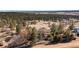 Scenic aerial view showcasing the home nestled within a lush, tree-filled landscape at 7596 Rafter Rd, Franktown, CO 80116