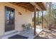 Cozy back porch with seating, perfect for enjoying the outdoors and serene backyard views at 7596 Rafter Rd, Franktown, CO 80116