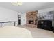 Bedroom features a brick fireplace, television, and view of bed, creating a cozy atmosphere at 7596 Rafter Rd, Franktown, CO 80116