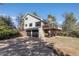 Exterior view of home with deck and large driveway at 7596 Rafter Rd, Franktown, CO 80116