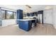 Spacious kitchen with a large island, blue cabinets, and stainless steel appliances at 7596 Rafter Rd, Franktown, CO 80116