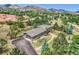 Expansive aerial view of home showcasing mature trees, large driveway, and complementary architectural details at 6227 Colorow Dr, Morrison, CO 80465