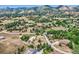 Expansive aerial view highlights the neighborhood's mature trees, open space, and mountain views at 6227 Colorow Dr, Morrison, CO 80465