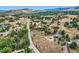 Stunning aerial view of the property showcasing its location among lush greenery and dramatic rock formations at 6227 Colorow Dr, Morrison, CO 80465