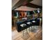 Stylish home bar with seating and ample counter space at 6227 Colorow Dr, Morrison, CO 80465