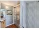 Modern bathroom with a large shower, wood accents, and a sliding glass door at 6227 Colorow Dr, Morrison, CO 80465