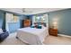 Comfortable bedroom with a ceiling fan, natural light, and pleasant blue walls at 6227 Colorow Dr, Morrison, CO 80465