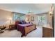 Bedroom featuring natural light, decorative window treatments, and wood furniture at 6227 Colorow Dr, Morrison, CO 80465