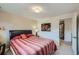 Cozy bedroom featuring a large bed, wood accents, and a view into an adjoining room at 6227 Colorow Dr, Morrison, CO 80465