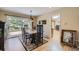 Dining room with hardwood floors, modern chandelier, and sliding glass doors to the backyard at 6227 Colorow Dr, Morrison, CO 80465