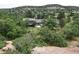 Secluded home with a serene view surrounded by lush trees at 6227 Colorow Dr, Morrison, CO 80465